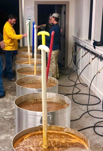 Members of Episcopal Church of the Ascension in Hattiesburg prepare over 1,000 quarts of gumbo in January 2024. The church sells the gumbo to fund its outreach ministries. The gumbo is said to be ready when the stirring paddles stand up in the center of the 160-quart pots.