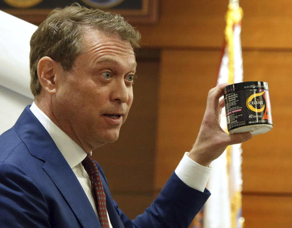 John J. Uustal, attorney for Tramar Dillard, also known as Flo Rida, holds a can of Celsius powdered drink that was part of an endorsement deal between the rapper and the company at the Broward County Courthouse, Tuesday, Jan 17, 2023, in Fort Lauderdale, Fla. Flo Rida is suing the drink maker for breach of contract. (Joe Cavaretta/South Florida Sun-Sentinel via AP)