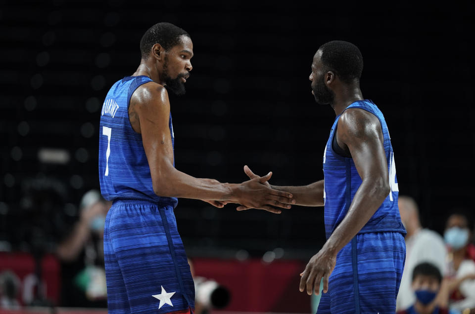 United States' Kevin Durant (7), left, celebrates with teammate Draymond Green (14) after their win in the men's basketball quarterfinal game against Spain at the 2020 Summer Olympics, Tuesday, Aug. 3, 2021, in Saitama, Japan. (AP Photo/Charlie Neibergall)