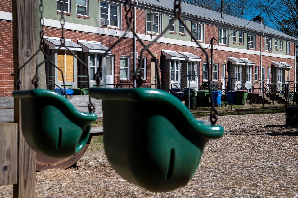 Boarded windows are seen from a playground at Pisgah View Apartments in West Asheville, February 15, 2024.