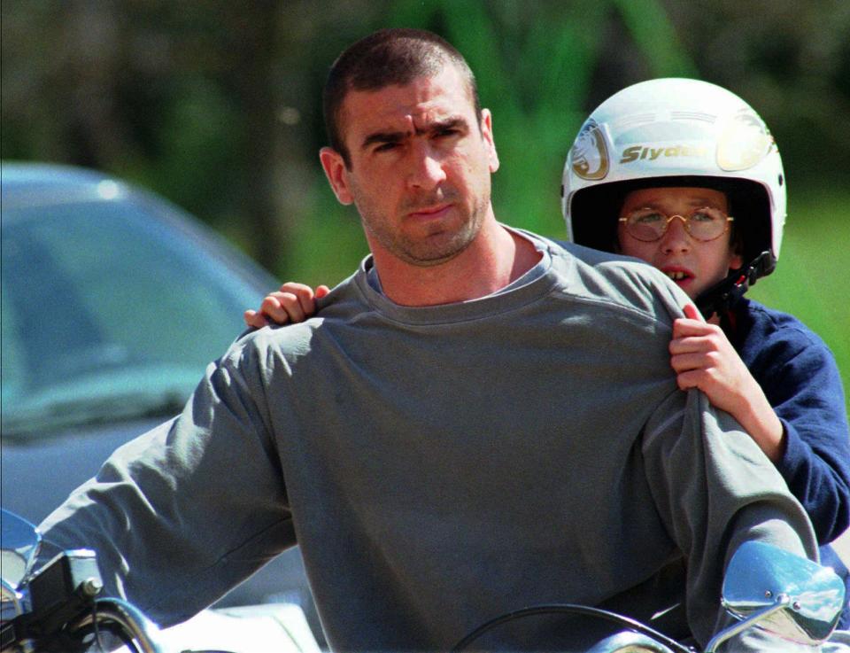 French national team and Manchester United soccer star Eric Cantona, who retired from the game Sunday, takes a motorcycle ride with his son Raphael in Villard, southern France Wednesday May 21, 1997, where he is on vacation. (AP Photo/Patrick Gardin)