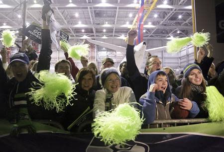 Delta employees and their families greet the Seattle Seahawks football team as their flight returns home after winning NFL Super Bowl XLVIII at Sea-Tac Airport in Seattle, Washington February 3, 2014. REUTERS/Jason Redmond