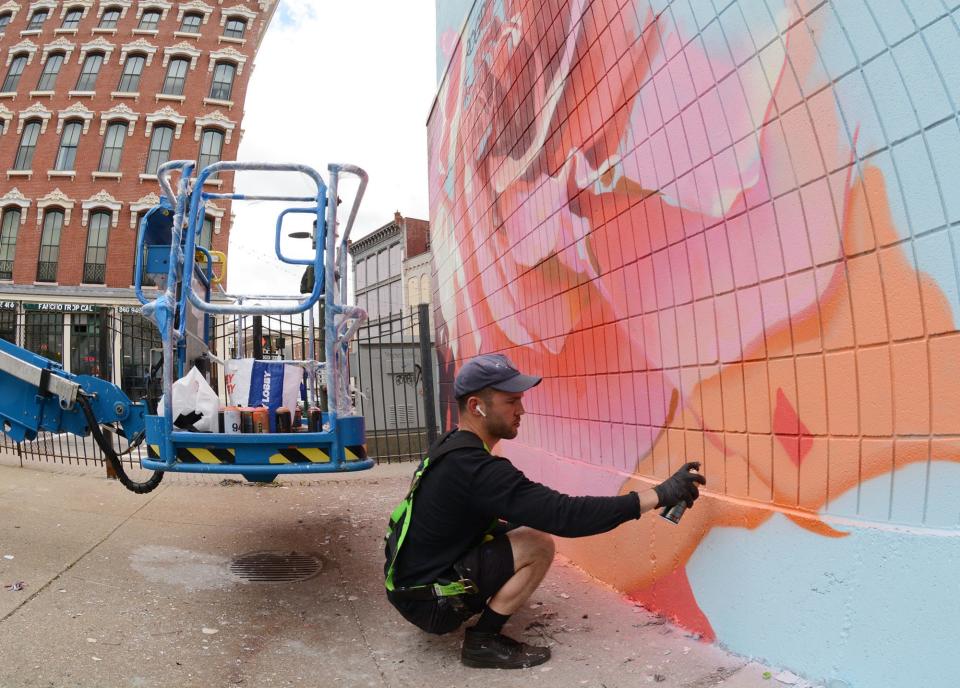Mural artist Ben Keller paints a rose as part of a 50-by-50 foot mural at soon-to-be Jubilee Park, a public space at Castle Church in downtown Norwich. The mural will feature two important Black figures in Norwich’s history, James Lindsey Smith and Sarah Harris Fayerweather.