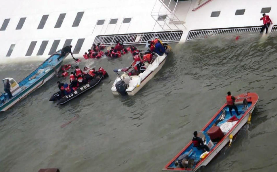 In this image taken from video from Mokpo Coast Guard, passengers from a ferry sinking off South Korea's southern coast, are rescued by South Korean Coast guard in the water off the southern coast near Jindo, south of Seoul, Wednesday, April 16, 2014. Nearly 300 people were still missing Wednesday several hours after the ferry carrying 477, most of them high school students, sank in cold waters off South Korea's southern coast. (AP Photo/Yonhap) KOREA OUT