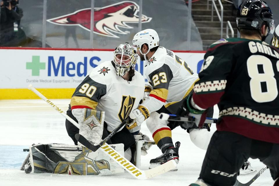 Arizona Coyotes right wing Conor Garland (83) scores a goal against Vegas Golden Knights goaltender Robin Lehner (90) as Golden Knights defenseman Alec Martinez (23) looks for the puck during the third period of an NHL hockey game Friday, Jan. 22, 2021, in Glendale, Ariz. (AP Photo/Ross D. Franklin)