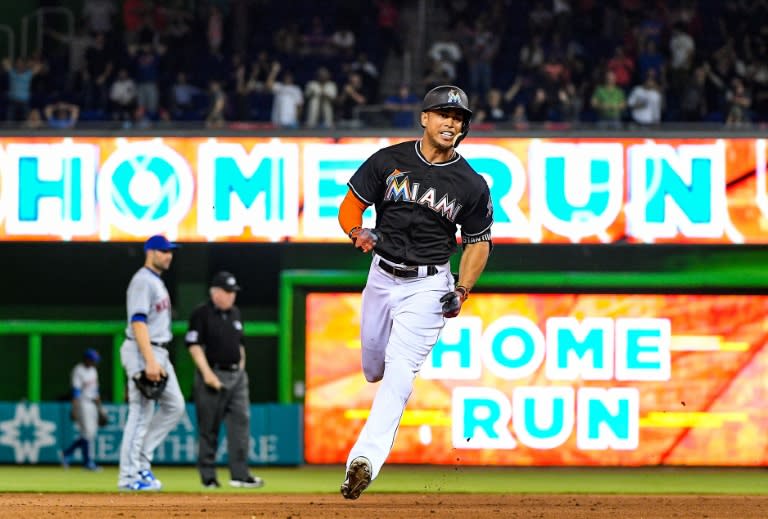 Giancarlo Stanton of the Miami Marlins hits the go ahead homerun in the eighth inning during their game against the New York Mets, at Marlins Park in Miami, Florida, on April 15, 2017