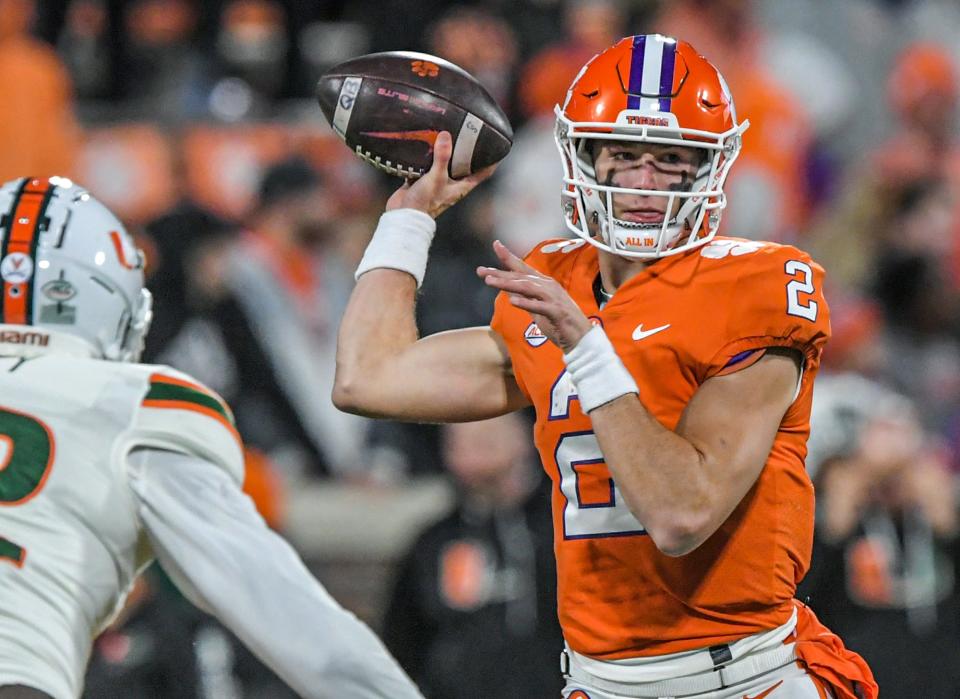 Clemson quarterback Cade Klubnik (2) passes near Miami defensive lineman Myjalik Kelly (32) during the fourth quarter at Memorial Stadium in Clemson, South Carolina Saturday, Nov. 19, 2022.