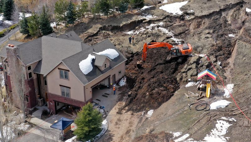 Crews work to remove mud at the scene of a mudslide in Morgan on Monday, April 17, 2023.