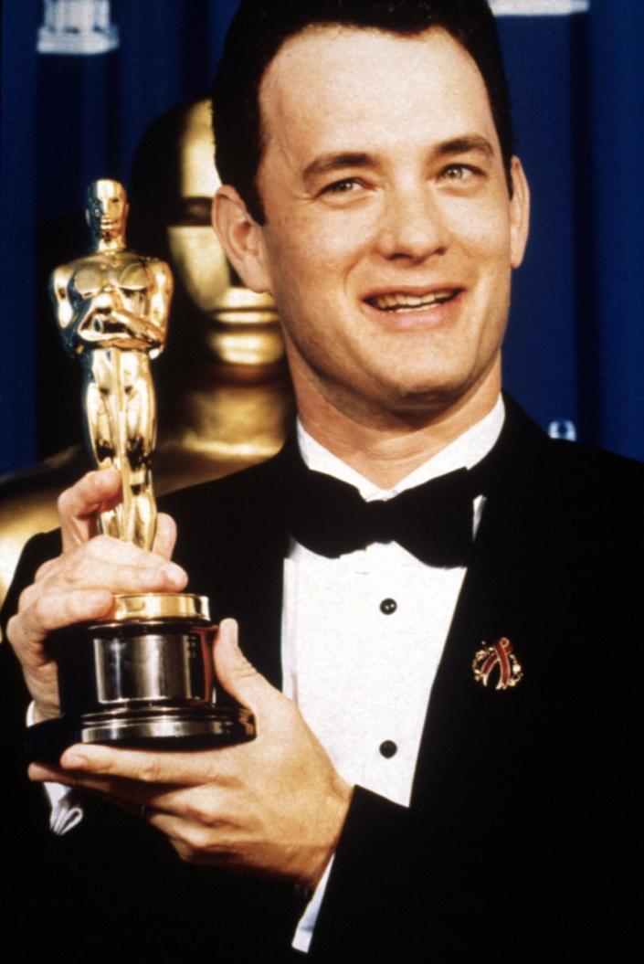 Tom Hanks holding an Oscar