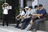 Members of the Nationalist Party, or KMT, wait to cast their ballot for election of its party chairman at a polling station in Taipei, Taiwan, Saturday, Sept. 25, 2021. Fraught relations with neighboring China are dominating Saturday's election for the leader of Taiwan’s main opposition Nationalist Party. (AP Photo/Chiang Ying-ying)