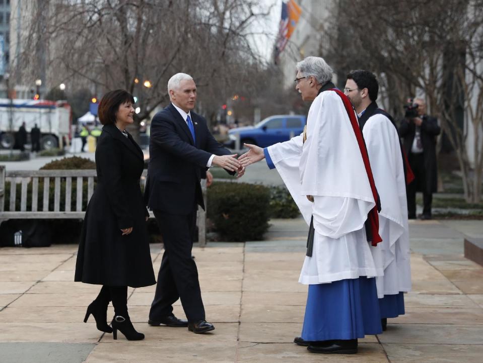 Rev. Luis Leon greets Vice President-elect Mike Pence and his wife Karen as they arrive for a church service at St. John’s Episcopal Church across from the White House in Washington, Friday, Jan. 20, 2017, on Donald Trump's inauguration day. (AP Photo/Alex Brandon)