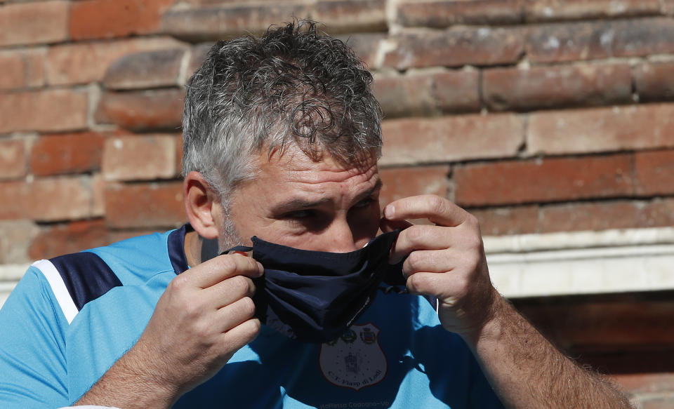 Mattia Maestri adjusts his face mask prior to the start of a 180-kilometer relay race, in Codogno, Italy, Saturday, Sept. 26, 2020. Italy’s coronavirus Patient No. 1, whose case confirmed one of the world’s deadliest outbreaks was underway, is taking part in a 180-kilometer relay race as a sign of hope for COVID victims after he himself recovered from weeks in intensive care. Mattia Maestri, a 38-year-old Unilever manager, was suited up Saturday for the start of the two-day race between Italy’s first two virus hotspots. It began in Codogno, where Maestri tested positive Feb. 21, and was ending Sunday in Vo’Euganeo, where Italy’s first official COVID death was recorded the same day. (AP Photo/Antonio Calanni)