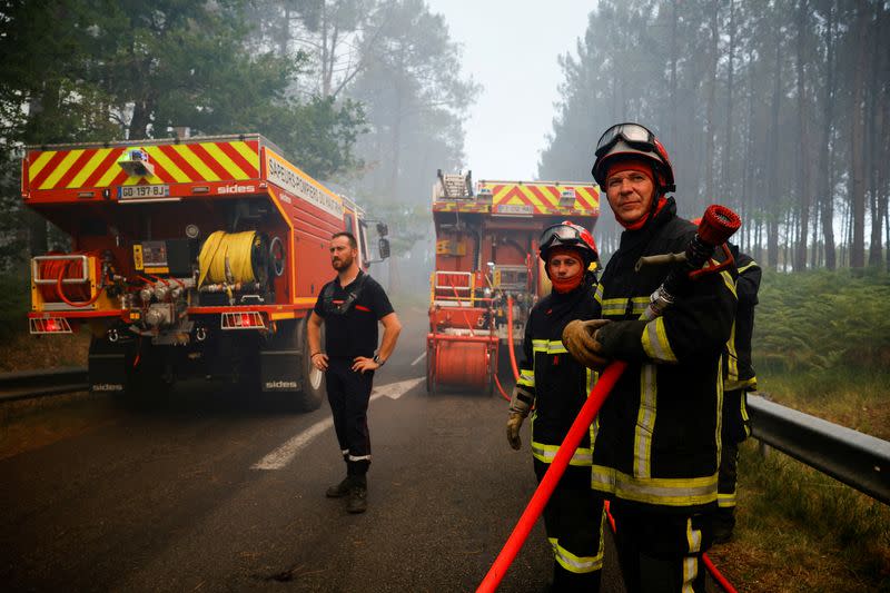 FILE PHOTO: Firefighters work to contain a fire in Guillos, as wildfires continue to spread in the Gironde region of southwestern France