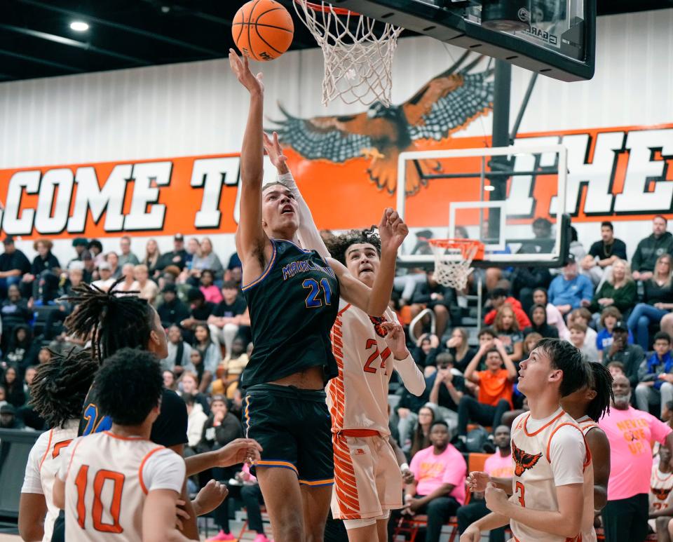 Mainland's DeAndre Newland (21) hits a layup against Spruce Creek during a game at Spruce Creek High School, Friday, Jan. 12, 2024.