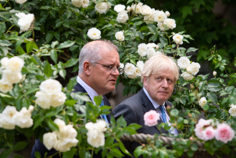 TOPSHOT - Britain's Prime Minister Boris Johnson (R) and Australia's Prime Minister Scott Morrison walk in the garden of 10 Downing street in central London on June 15, 2021. - Britain has agreed a post-Brexit free trade deal with Australia, London announced today, adding that the nations plan to 