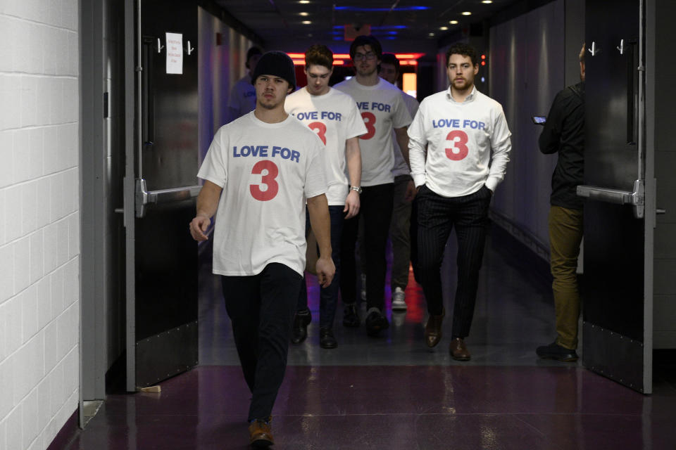 Buffalo Sabres players walk towards the locker room upon arriving wearing shirts in support of Buffalo Bills football player Damar Hamlin before an NHL hockey game against the Washington Capitals, Tuesday, Jan. 3, 2023, in Washington. (AP Photo/Nick Wass)