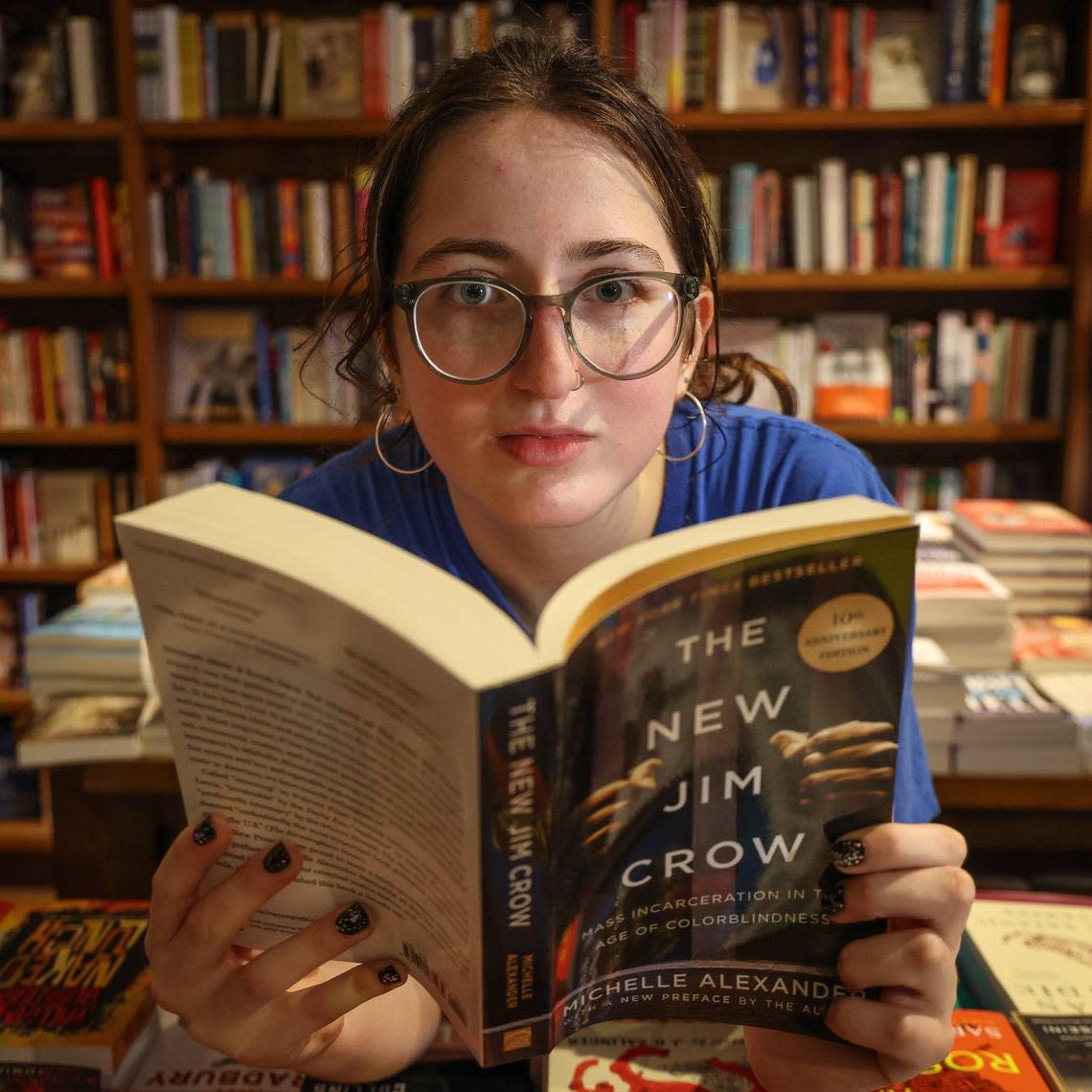 Iris Mogul, a high school student who started a banned books club, is photographed with one of her favorite books during the “Walk for Freadom” kickoff event on Sunday, October 1, 2023 in Coral Gables, Florida. The march began at the Coral Gables Congregational United Church of Christ and ended at Books & Books.