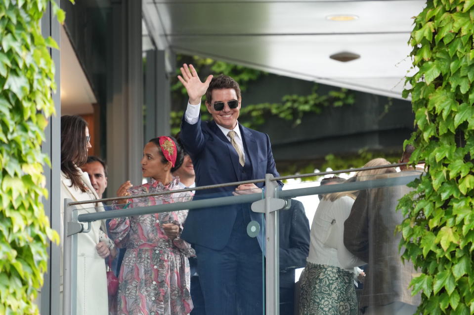 Actor Tom Cruise waves at the end of the women's singles final match between Australia's Ashleigh Barty and Czech Republic's Karolina Pliskova on day twelve of the Wimbledon Tennis Championships in London, Saturday, July 10, 2021. (AP Photo/Alberto Pezzali)