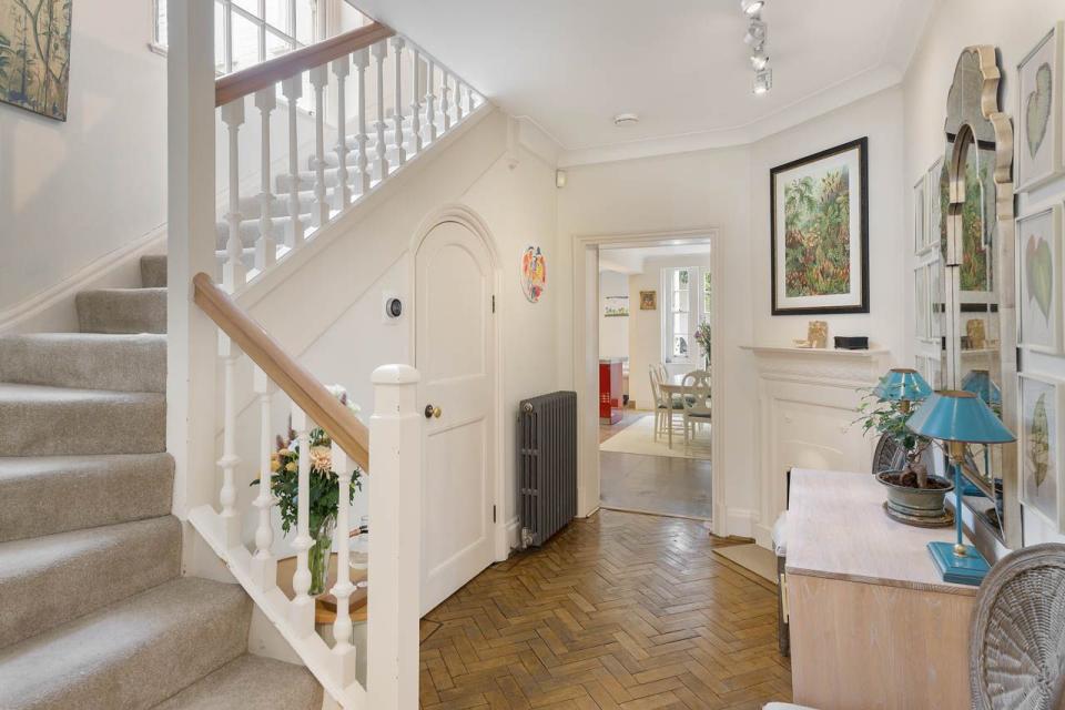 hallway with wooden flooring and white interiors