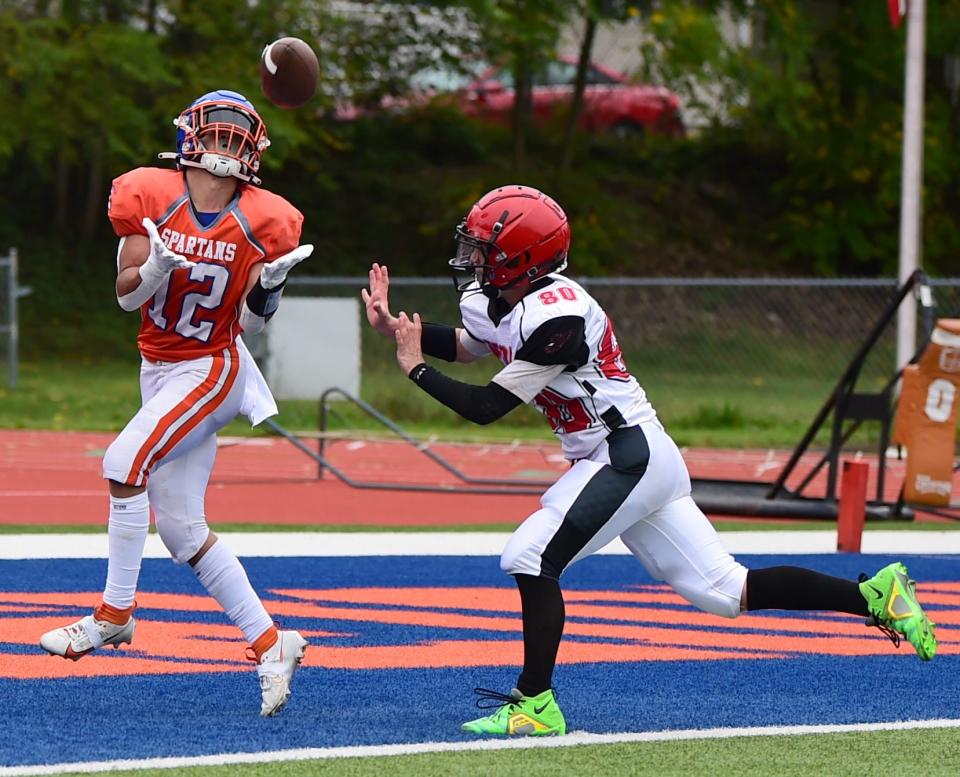 Thomas A. Edison's Reyes McAtee catches a touchdown pass in front of Oxford's Dominck Howe during the Spartans' 50-0 win in 8-man football Sept. 9, 2023 in Elmira Heights.