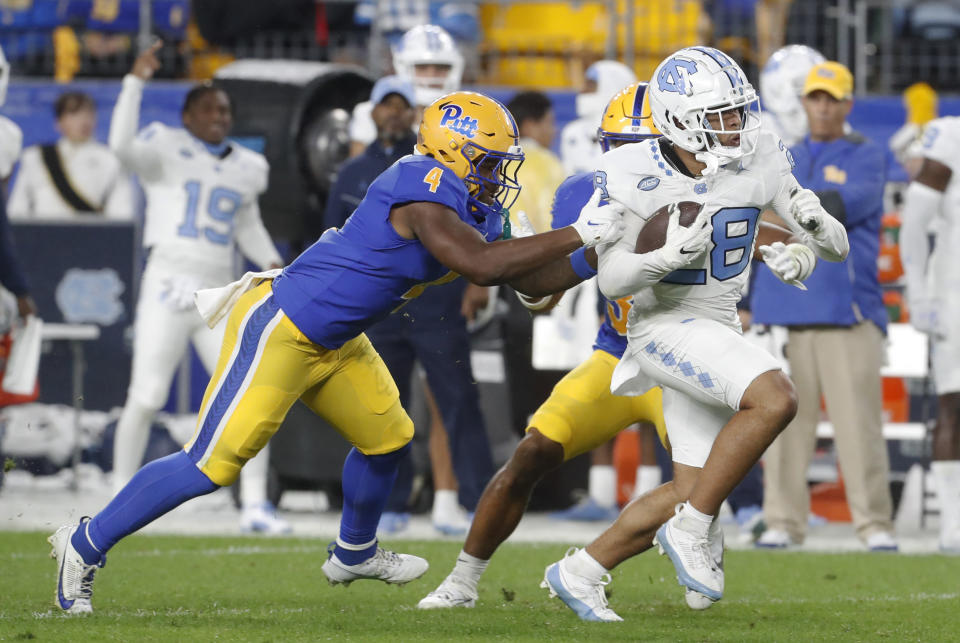 Sep 23, 2023; Pittsburgh, Pennsylvania, USA; North Carolina Tar Heels defensive back Alijah Huzzie (28) runs on his way to scoring on a fifty-two yard punt return against the Pittsburgh Panthers during the second quarter at Acrisure Stadium. Mandatory Credit: Charles LeClaire-USA TODAY Sports