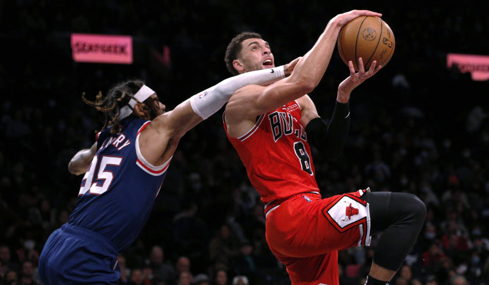 Chicago Bulls guard Zach LaVine (8) is fouled on his way to the basket by Brooklyn Nets' DeAndre Bembry (95) during the first half of an NBA basketball game in New York, Saturday, Dec. 4, 2021. (AP Photo/Noah K. Murray)