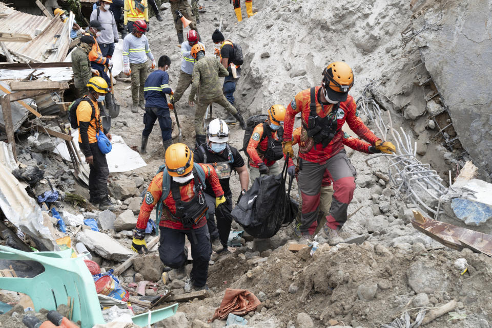 Rescuers carry a body from the landslide-hit village of Masara in Maco, Davao de Oro province, southern Philippines on Thursday Feb. 8, 2024. A landslide in the southern Philippines left a number of villagers dead and several others missing, including miners waiting in buses for a ride home, officials said Wednesday. (AP Photo)