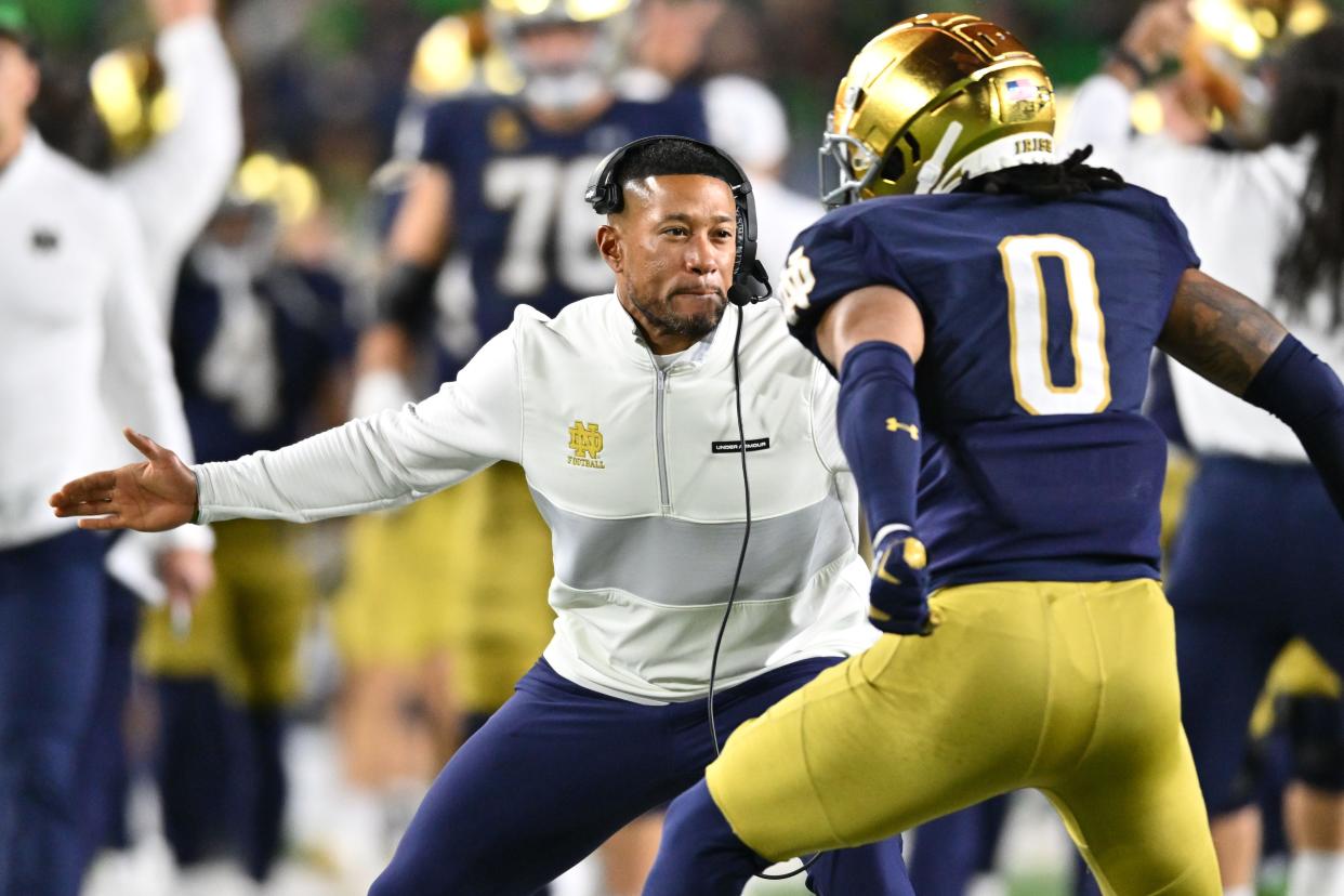 Oct 14, 2023; South Bend, Indiana, USA; Notre Dame Fighting Irish head coach Marcus Freeman celebrates with safety Xavier Watts (0) after Watts intercepted a pass in the first quarter against the USC Trojans at Notre Dame Stadium. Notre Dame won 48-20. Mandatory Credit: Matt Cashore-USA TODAY Sports