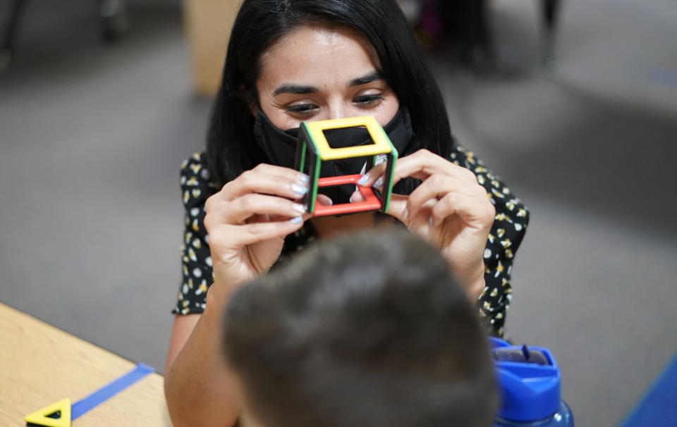 Teacher Juliana Urtubey works with a student in a class at Kermit R Booker Sr Elementary School Wednesday, May 5, 2021, in Las Vegas. Urtubey is the the 2021 National Teacher of the Year. (AP Photo/John Locher)