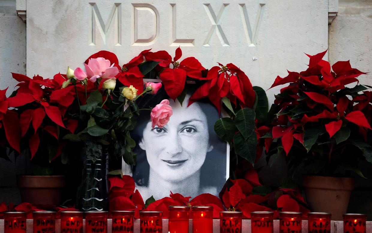 An image of journalist Daphne Caruana Galizia at a makeshift shrine in Valletta - Reuters