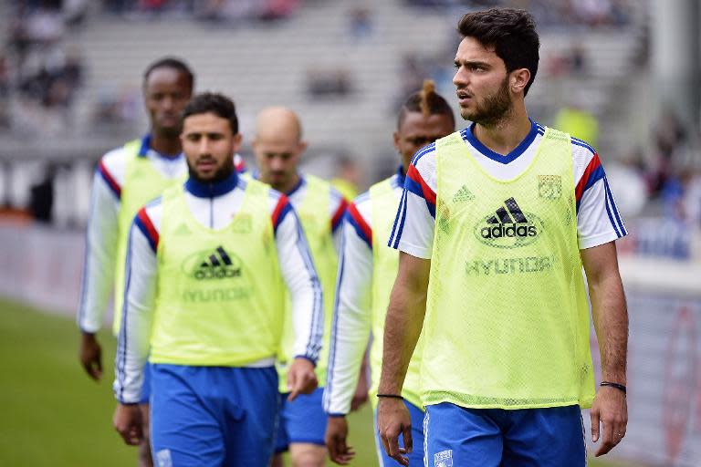 Lyon's midfielder Clement Grenier (R) arrives with teammates ahead of their French Ligue 1 match against Evian, at the Gerland Stadium in Lyon, central eastern France, on May 2, 2015