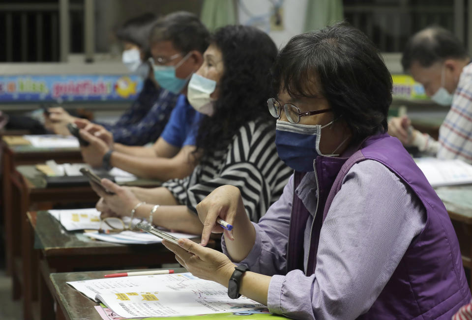 Students of Fake News Cleaner learn how to use the LINE app to identify fake news during a class in Kaohsiung City, southern Taiwan, Thursday, March 16, 2023. An anti-misinformation group in Taiwan called Fake News Cleaner has hosted more than 500 events, connecting with college students, elementary-school children — and the seniors that, some say, are the most vulnerable to such efforts. (AP Photo/Chiang Ying-ying)