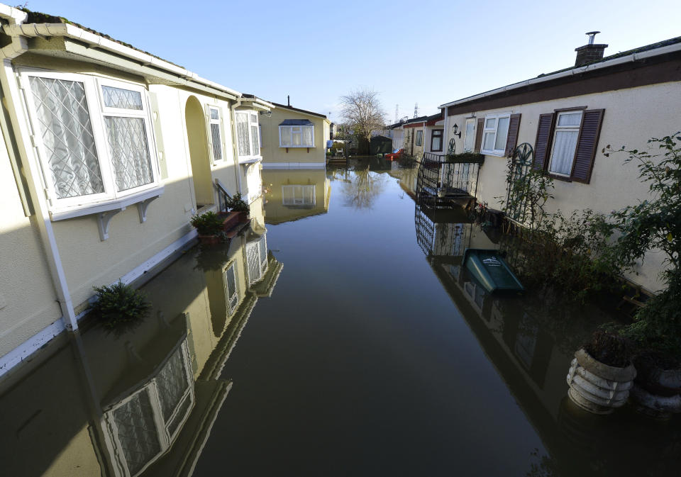 Riverside properties are seen partially submerged in floodwaters from the River Thames, at Chertsey in southern England, January 13, 2014. Britain's insurers are preparing to pay out hundreds of millions of pounds in claims following a run of winter storms that have flooded homes and disrupted travel, though the absence of major damage should limit the impact on their 2013 results. More than 1,700 homes and businesses have been affected by the floods in England since late December, which also killed seven people, according to news reports. REUTERS/Toby Melville (BRITAIN - Tags: ENVIRONMENT DISASTER)