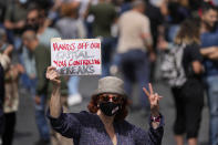 FILE- A demonstrator holds a placard during a protest against a new draft law on capital controls on savings withdrawals outside the parliament building, in downtown Beirut, Lebanon, Tuesday, April 26, 2022. Lebanon and Sri Lanka may be a world apart, but they share a history of political turmoil and violence that led to the collapse of once-prosperous economies bedeviled by corruption, patronage, nepotism and incompetence. (AP Photo/Hussein Malla, File)