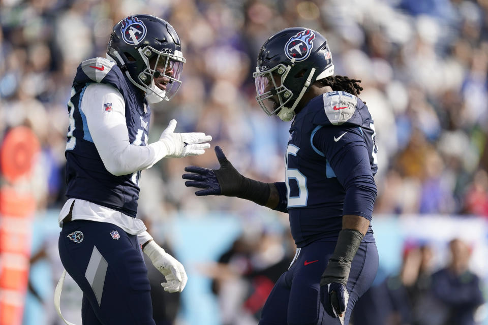 Tennessee Titans linebacker Arden Key, left, is congratulated by defensive end Denico Autry after sacking Seattle Seahawks quarterback Geno Smith during the first half of an NFL football game on Sunday, Dec. 24, 2023, in Nashville, Tenn. (AP Photo/George Walker IV)