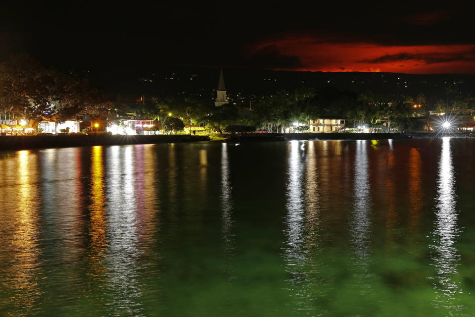 The glow of the Mauna Loa eruption is seen from Kona Bay, Monday, Nov. 28, 2022, in Kona, Hawaii. Mauna Loa, the world's largest active volcano erupted Monday for the first time in 38 years. (AP Photo/Marco Garcia)