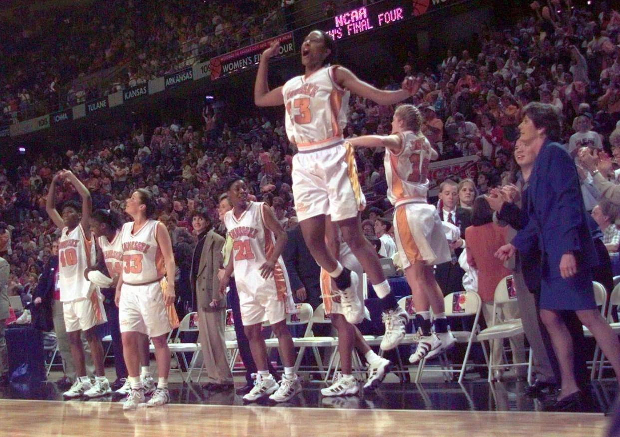 FILE - Tennessee's Chamique Holdsclaw (23) jumps in celebration with her teammates on the sidelines after winning the championship game of the women's Final Four at Kemper Arena in Kansas City, Mo., Sunday, March 29, 1998. Tennessee finished 39-0 in 1998. (AP Photo/Orlin Wagner, File)