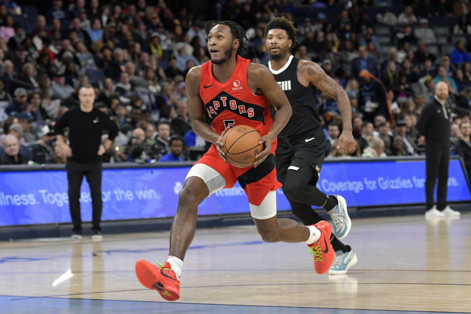 Toronto Raptors guard Immanuel Quickley (5) drives in front of Memphis Grizzlies guard Marcus Smart during the second half of an NBA basketball game Wednesday, Jan. 3, 2024, in Memphis, Tenn. (AP Photo/Brandon Dill)