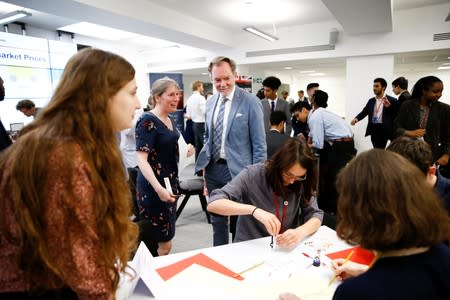 Britain's Chief Trade Negotiation Adviser Crawford Falconer watches students take part in a mock trade negotiation at Harris Westminster Sixth Form college in central London