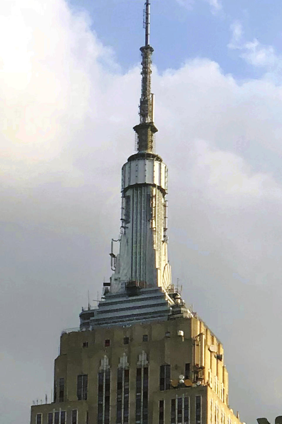 This Aug. 22, 2019 photo, provided by Robert Krizman shows the "cocoon" enclosure surrounding circular 102nd floor Observatory of the Empire State Building under construction, in New York. The observatory has a dizzying new look with floor-to-ceiling, 360-degree windows 102 floors above New York City. The remodeled observatory was unveiled Thursday, Oct. 10, 2019 and opens to the public Saturday. (Photo Courtesy of Robert Krizman via AP)