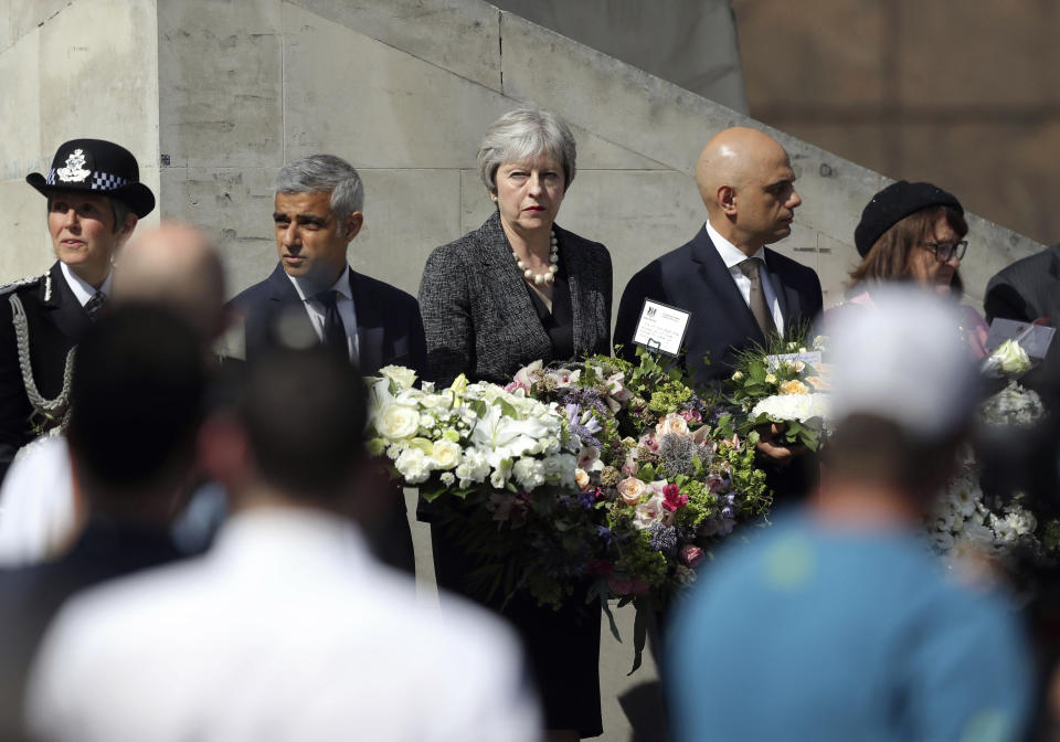 From left, Metropolitan Police Commissioner Cressida Dick, Mayor of London Sadiq Khan, Prime Minister Theresa May and Home Secretary Sajid Javid at Southwark Gateway Needle, on the south side of London Bridge on June 3, 2018, ahead of a minute's silence to mark one year since a deadly vehicle-and-knife attack on London Bridge (Andrew Matthews/PA via AP)