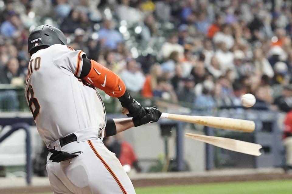 San Francisco Giants' Michael Conforto hits a broken bat single during the sixth inning of a baseball game against the Milwaukee Brewers Friday, May 26, 2023, in Milwaukee. (AP Photo/Morry Gash)