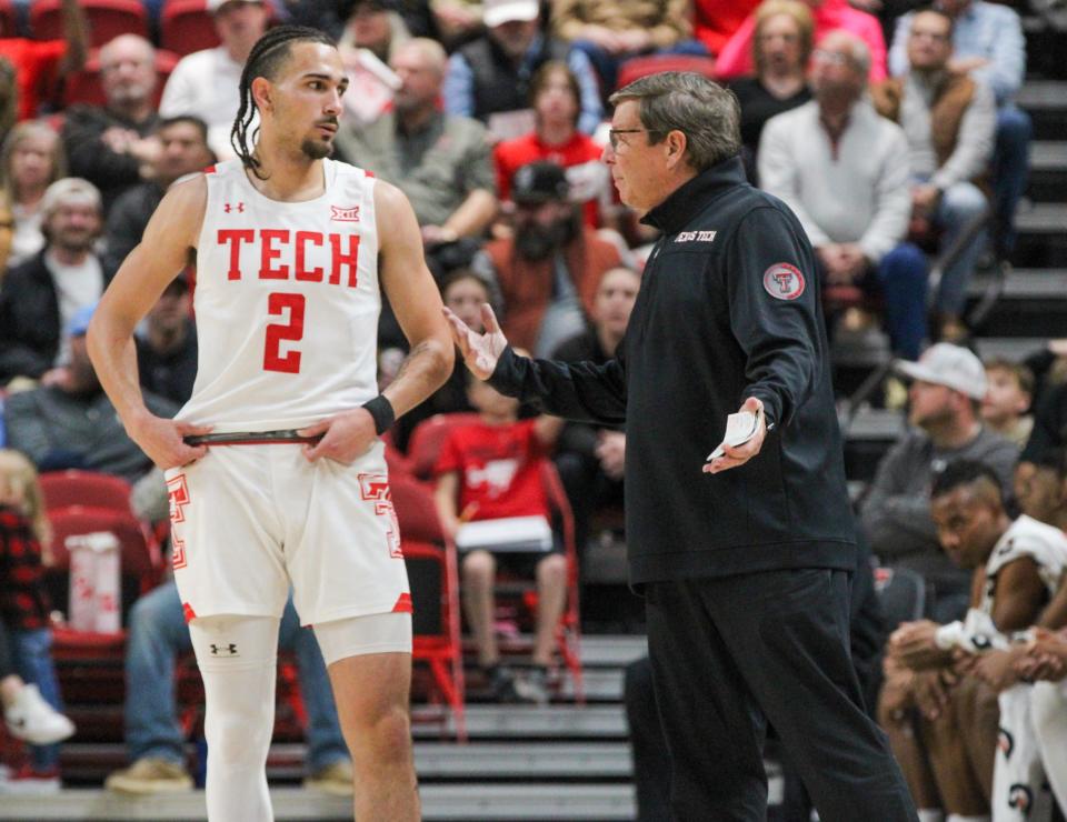 Texas Tech head coach Mark Adams (right) talks with Pop Isaacs during a non-conference men's basketball game on Tuesday, December 27, 2022 in United Supermarkets Arena.