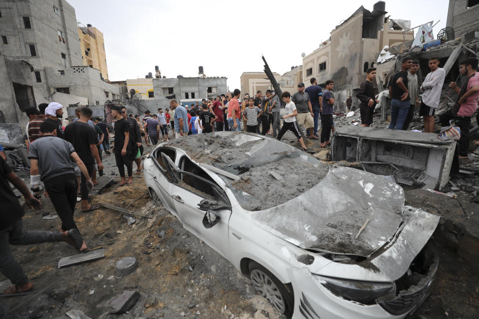 Palestinians inspect the rubble of a destroyed building after an Israeli airstrike in Deir al Balah, Gaza Strip, Friday, Oct. 27, 2023. (AP Photo/Ali Mahmoud)