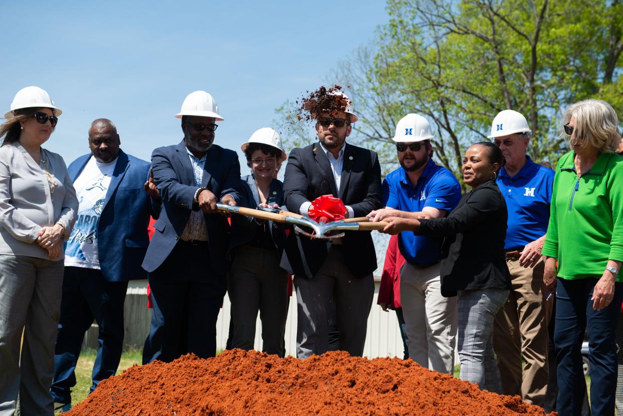Members of the Jackson government lifts a patch of dirt in the air to commemorate the Men's Homeless Shelter groundbreaking in Jackson Tenn. on Wednesday, Apr. 19, 2023. 
