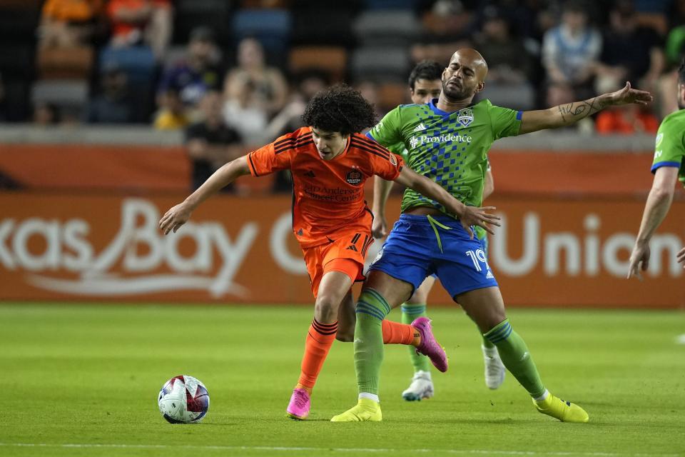 Houston Dynamo's Iván Franco, left, is fouled by Seattle Sounders' Héber (19) during the first half of an MLS soccer match Saturday, May 13, 2023, in Houston. (AP Photo/David J. Phillip)