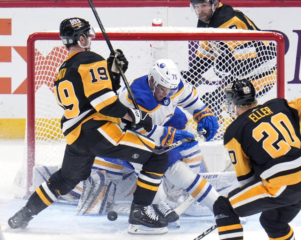 Pittsburgh Penguins' Reilly Smith (19) can't get his stick on a rebound off Buffalo Sabres goaltender Ukko-Pekka Luukkonen, with Connor Clifton (75) defending during the third period of an NHL hockey game Saturday, Jan. 6, 2024, in Pittsburgh. The Sabres won 3-1. (AP Photo/Gene J. Puskar)