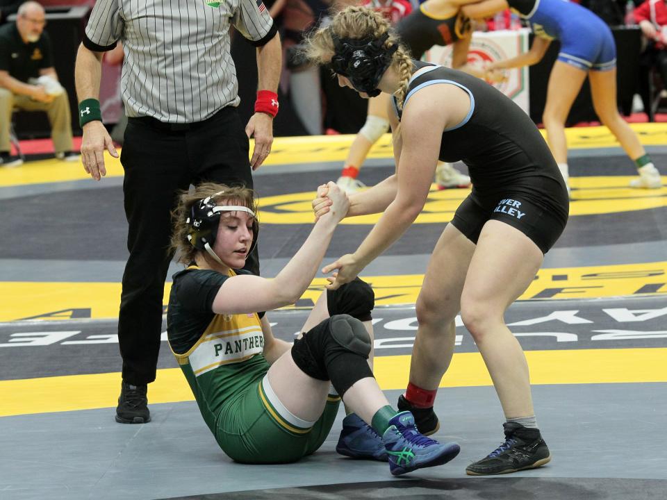 River Valley's Lila Mencer helps her opponent off the mat during this year's girls state wrestling tournament held for the first time at Ohio State's Schottenstein Arena. Mencer finished fifth in the state in the 135-pound weight class.