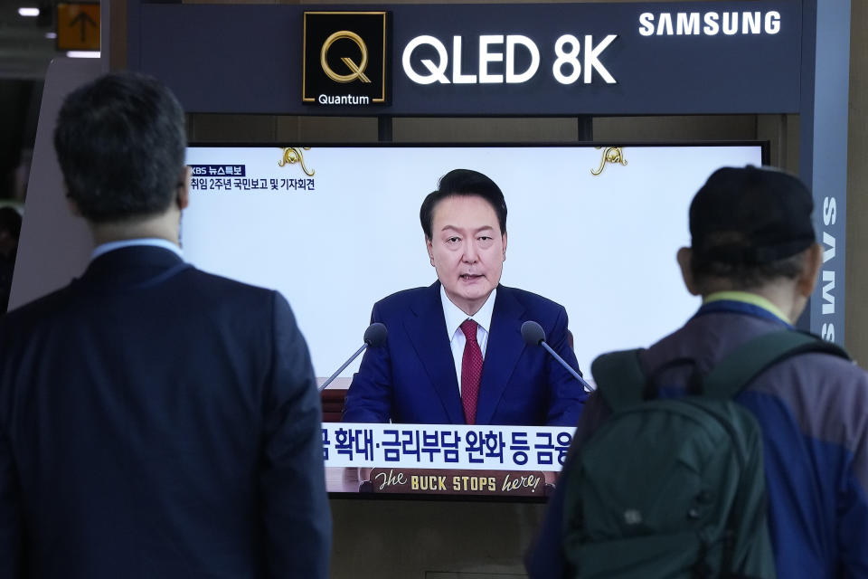 People watch a TV screen showing the live broadcast of South Korean President Yoon Suk Yeol's press conference, at the Seoul Railway Station in Seoul, South Korea, Thursday, May 9, 2024. South Korea’s president on Thursday dismissed calls for independent investigations into allegations involving his wife and top officials, a move expected to draw strong rebukes from his rivals. (AP Photo/Ahn Young-joon)