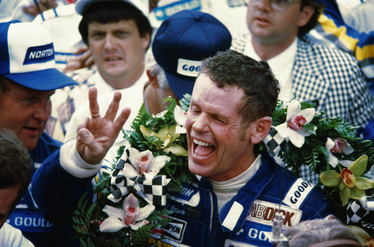 Race car driver Bobby Unser celebrates after winning the Indianapolis 500. He was later penalized one lap and stripped of the title.